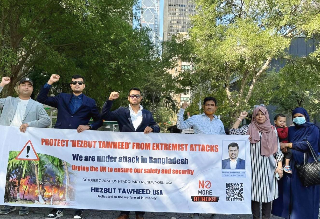 Hezbut Tawheed USA organized a human chain at the in front of United Nations Headquarters, calling on Secretary-General António Guterres to take action against the escalating extremist attacks targeting Hezbut Tawheed members in Bangladesh.  The protest took place on Monday, October 7, 2024, at 11 a.m. (New York time) in front of the UN Headquarters in New York, USA.  This event aimed to draw attention to the urgent need for protection for the movement's members, who have endured relentless violence from radical factions.  In the human chain, a plea was made to the United Nations Secretary-General António Guterres to take action to stop the ongoing attacks and threats, and a memorandum was submitted to him. Additionally, photos, and various documents of the threats and attacks on Hezbut Tawheed after August 5, as well as the destruction at the residence of the Imam of Hezbut Tawheed in 2009 and 2016, were provided.  Harun Al Rashid, the President of Hezbut Tawheed USA, delivered a speech during the event. He stated, The Hezbut Tawheed movement, a non-political religious reform initiative, has faced intensified attacks orchestrated by extremists aiming to eliminate the movement and its leader, Honorable Imam Hossain Mohammad Salim, in Noakhali District. Extremists have threatened to destroy the Imam’s residence, vandalized eight district offices, and attacked around fifty families, causing damages worth millions of BDT.  Over the past decade, Hezbut Tawheed has held 200,000 public awareness meetings against religious extremism, advocating interfaith harmony, women's inclusion, and cultural activities—values that sharply contrast with radical clerics' views,” stated Harun A Rashid. “This stance has made us targets for violent extremists.  Recently, extremists held multiple unlawful assemblies near the Imam’s residence, demanding that Hezbut Tawheed members vacate the area. This troubling trend includes incidents dating back to 2016, where false rumors led to looting, the destruction of a mosque, and the murder of two members, with no justice served since.  “We urge the United Nations to protect our members, particularly vulnerable women, children, and the elderly, from persecution and violence,” Harun A Rashid emphasized.  The demonstration featured powerful testimonies from Hezbut Tawheed USA members, underscoring the immediate need for international intervention to prevent further violence and safeguard human rights in Bangladesh.